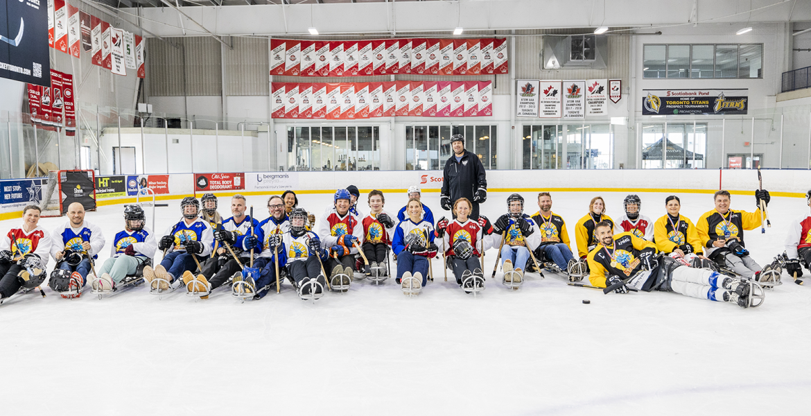 Team Photo of Sledge Hockey Players on Ice